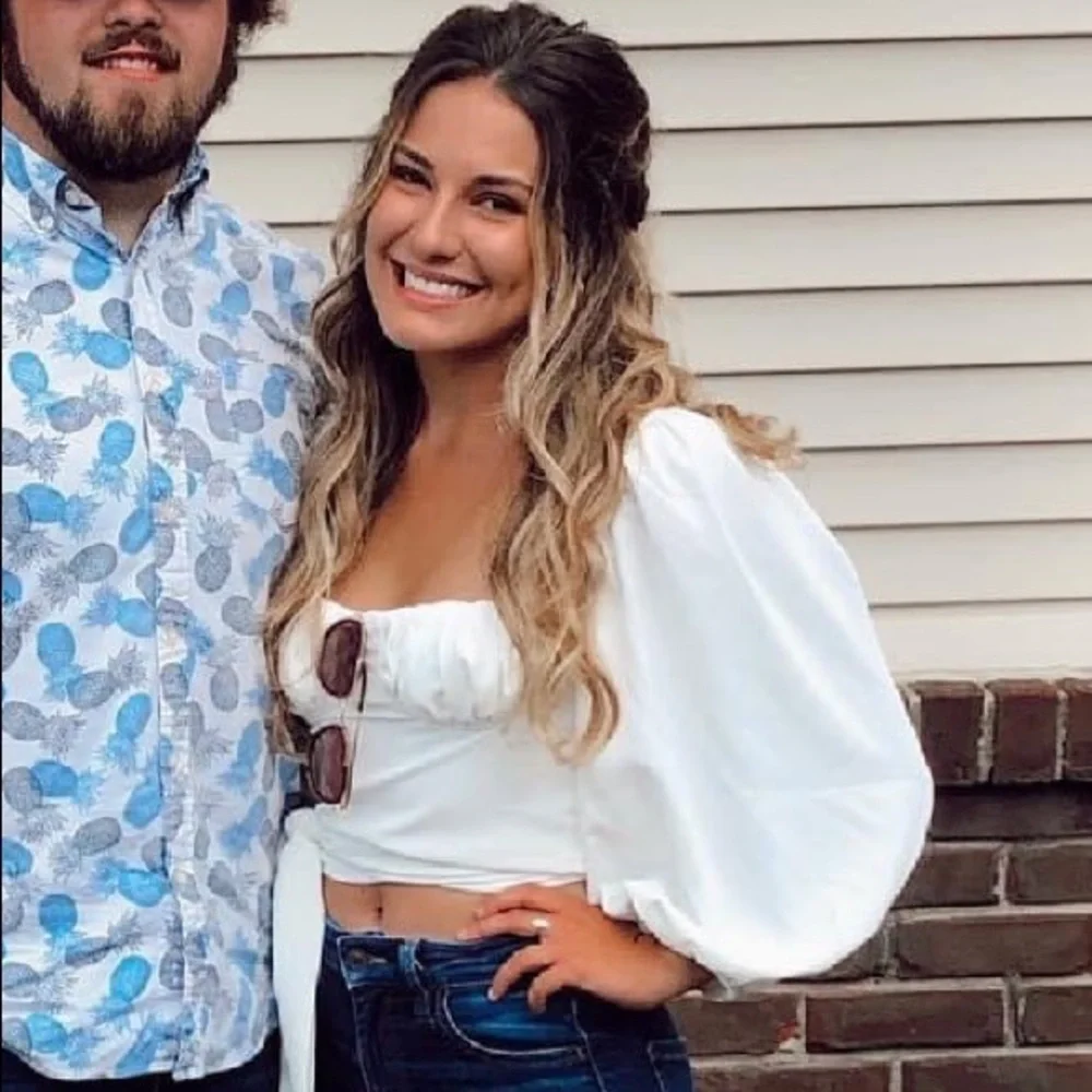 White long sleeve blouse with puff sleeves and a tie back. - Picture 1 of 5